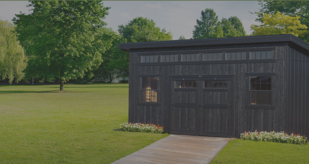 A black Mast Mini Barn Klassic Studio shed in black with bklack trim