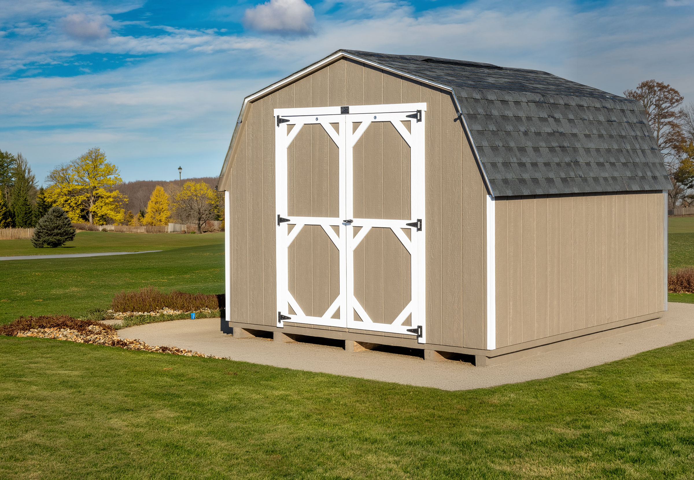 A Mast Mini Barn 8 foot painted Pro Series shed shown in Buck skin with white trim