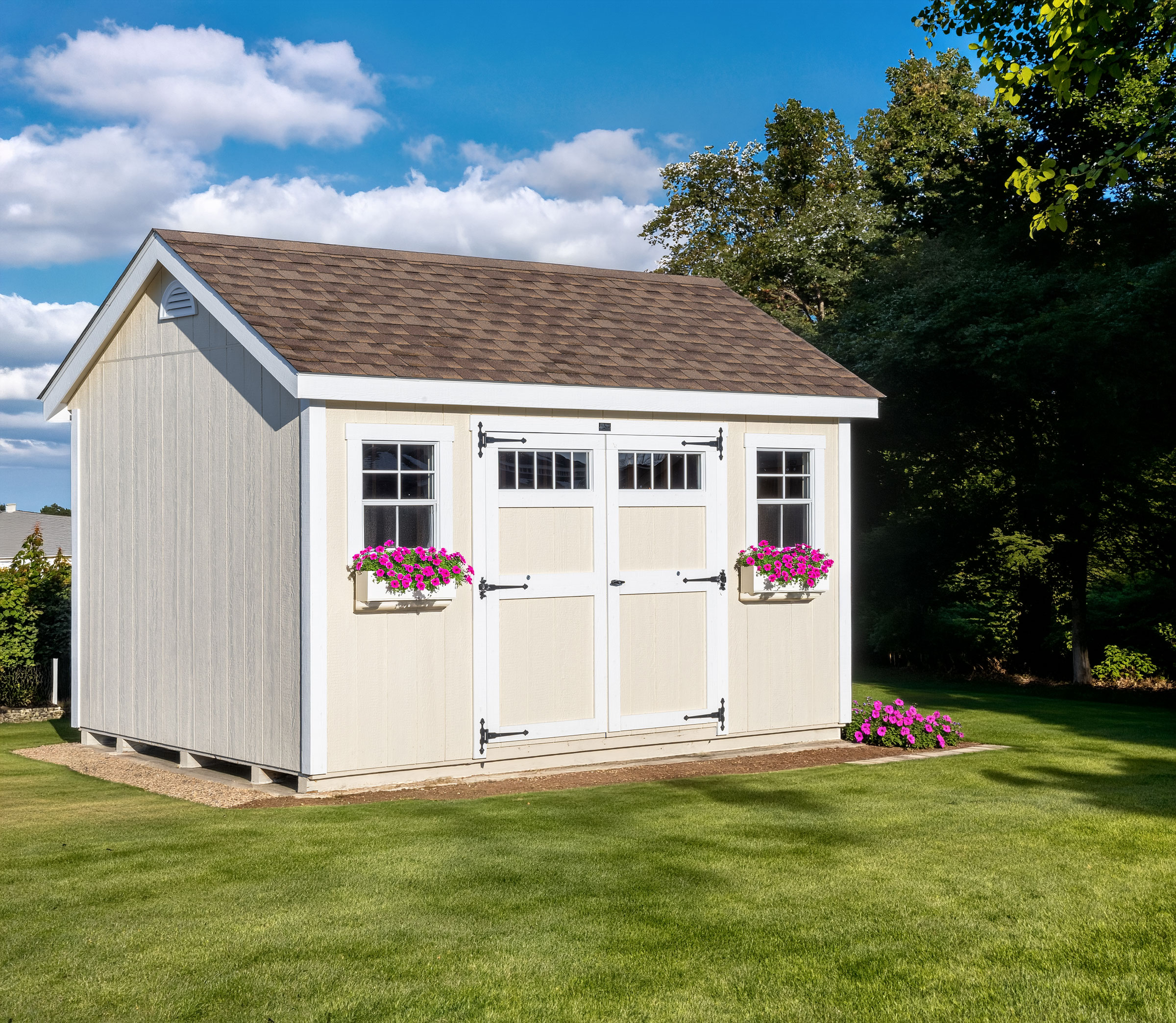 A 10x14 Mast Mini Barn Cape Cod shed shown in Navajo White with White trim, deluxe trim package