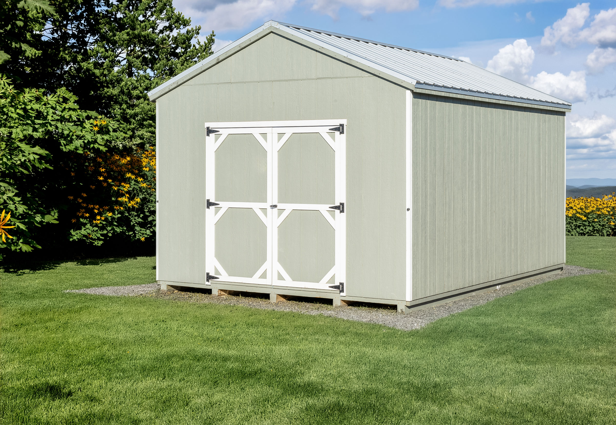 A Mast Mini Barn Pro Series Cottage shed sjown in Costal Sage with white trim