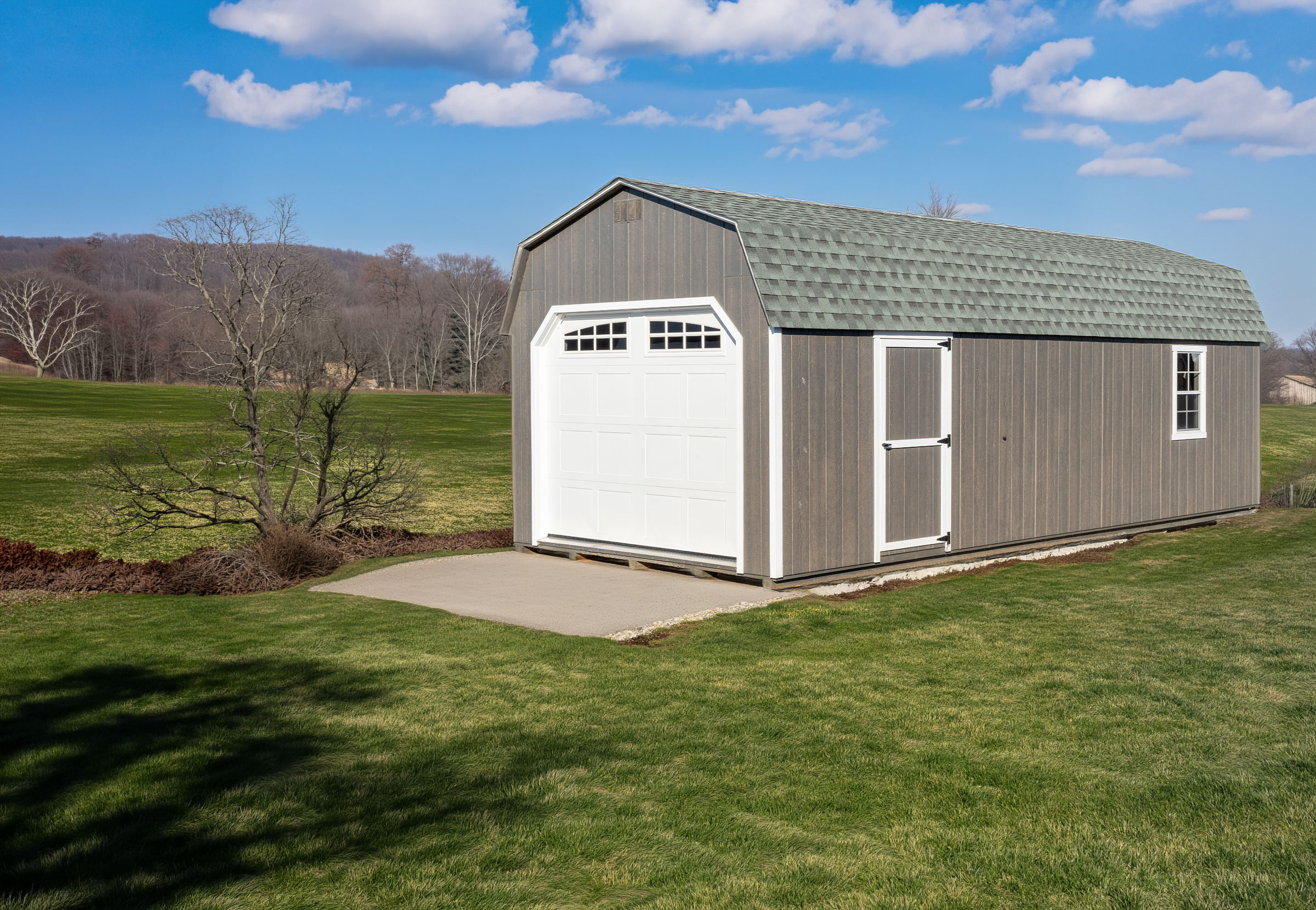 A Mast Mini Dutch Barn Garage shown in asphalt shingles, Charcoal Grey siding, and White trim